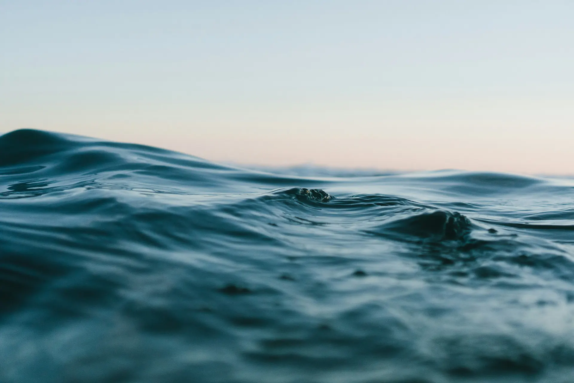 Gentle waves on open water at dusk